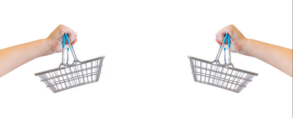 Kid’s hand carries Small shopping basket on white background. It is a symbol of online shopping.