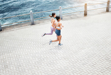 Beach, women and fitness friends running on sidewalk at the ocean for exercise, cardio workout and...