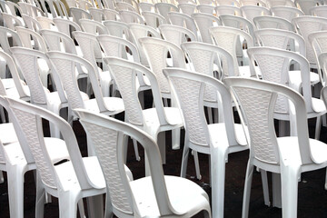 Rows of white seats. Empty chairs in the conference hall.