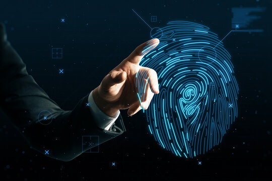 Close Up Of Businessman Hand Pointing At Abstract Glowing Finger Print Id Hologram On Dark Background. Fingerprint, Biometrics, Information Technology And Cyber Security Concept.