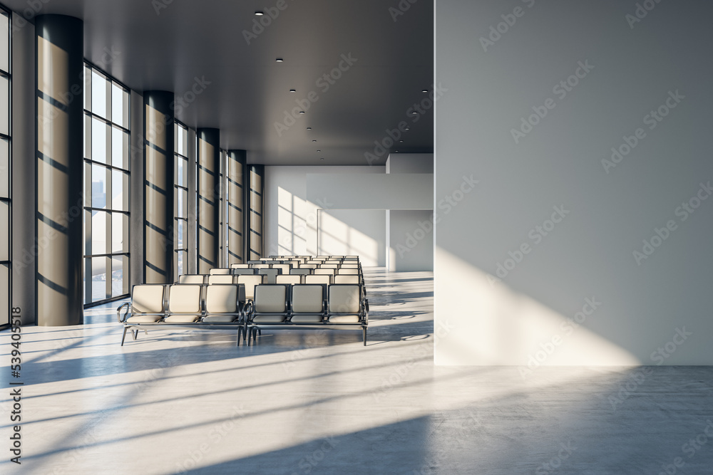 Poster front view on blank light grey wall with place for advertising poster in sunlit spacious empty airpo