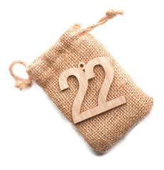 Wooden number twenty two, twenty second December, Advent calendar, wooden number on a transparent...