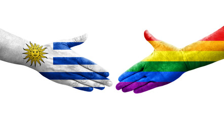 Handshake between LGBT and Uruguay flags painted on hands, isolated transparent image.