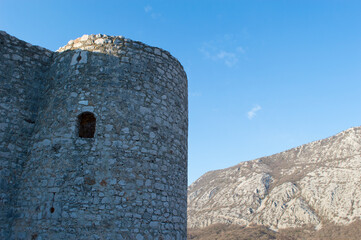 Medieval stone tower with small window, on the hill in Drivenik, Croatia
