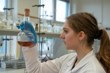young girl - scientist student are working in laboratory