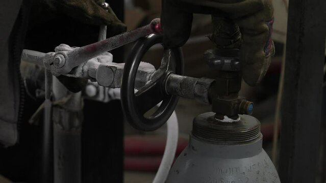 Cylinder valve. Gas bottling plant. 4K, UHD, 50p, Panning,Close-up, 