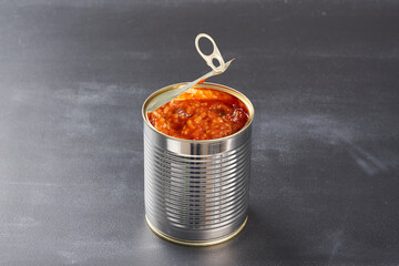 Open iron can on a dark background.