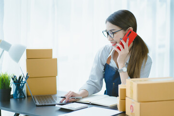 Asian teenager owner business woman work at home for online shopping and sale.