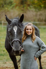 Fototapeta premium Woman on a horse at rancho. Horse riding, hobby time. Concept of animals and human
