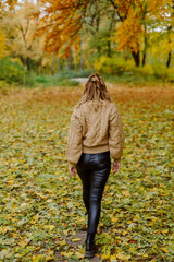 Woman walking in the autumn park, a healthy lifestyle, walk, exercise