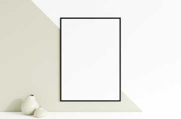 Clean and minimalist front view vertical black photo or poster frame mockup hanging on the wall with vase. 3d rendering.