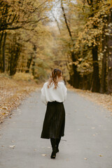 Woman walking in the autumn park, a healthy lifestyle, walk, exercise