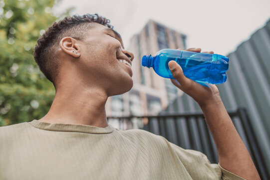 Young Sportsman Feeling Thirsty After Workout