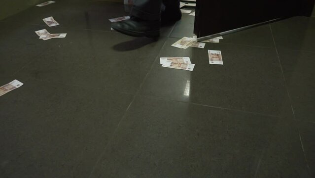 Men's feet and russians money rubles banknotes on the floor. High quality FullHD footage