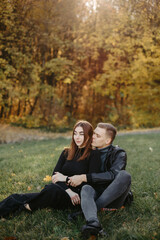 Lovely couple posing in autumn forest, lovers walking in park. lovestory in forest