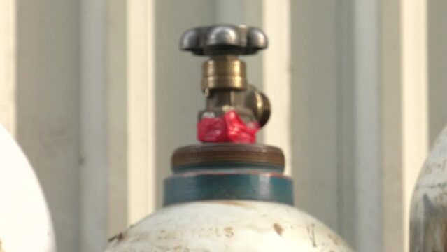 Cylinder valve. Gas bottling plant. 4K, UHD, 50p, Panning,Close-up, 