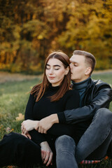 Naklejka premium Lovely couple posing in autumn forest, lovers walking in park. lovestory in forest