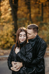 Lovely couple posing in autumn forest, lovers walking in park. lovestory in forest
