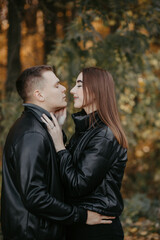 Lovely couple posing in autumn forest, lovers walking in park. lovestory in forest