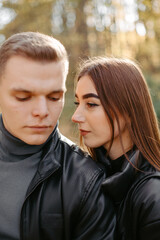 Fototapeta premium Lovely couple posing in autumn forest, lovers walking in park. lovestory in forest
