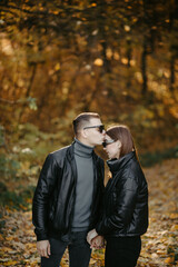 Lovely couple posing in autumn forest, lovers walking in park. lovestory in forest