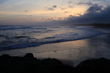 afternoon atmosphere on the beach with beautiful waves and orange sky