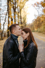 Lovely couple posing in autumn forest, lovers walking in park. lovestory in forest