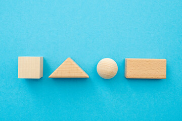Wooden geometric shapes, figures square, triangle, sphere, rectangle with blank surface for text on...