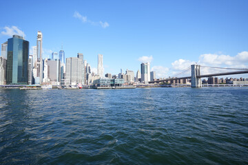 Fototapeta premium New York City, New York USA - September 2022. Manhattan bridge. Iron bridge view. Historic New York place. Brick wall buildings. Brownstone building.