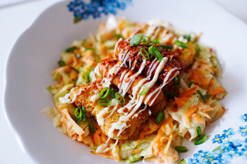 salad, chicken steak with mayo sauce and beef sausage sprinkled with scallions
