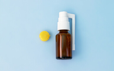 sore throat treatment concept.isolated on blue medicinal background one wooden spatula for neck checking red pain.electronic thermometer spray lozenges surgical gloves.flu virus bacteria   autumn cold