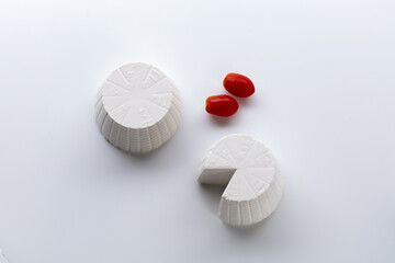 whole ricotta with fresh tomato on a white background