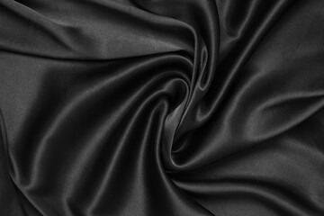 Black fabric texture background, wavy fabric slippery black color, luxury satin cloth texture.