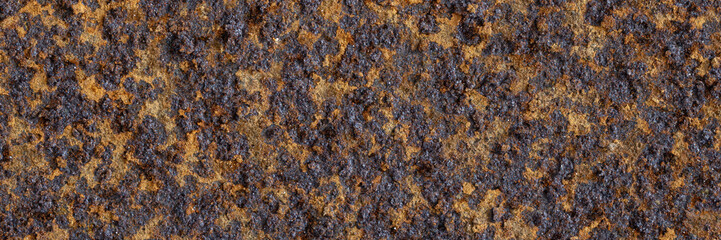 Texture of rusty metal. Rough metal surface with rust. Corroded and oxidized old iron. Rusted and aged metal sheet. Wide panoramic texture for background and design in grunge style.