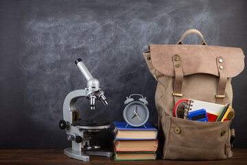 Back to school - books and school backpack on the desk in the auditorium, Education concept.