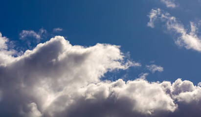 Naklejka na ściany i meble Clouds in dramatic blue sky.