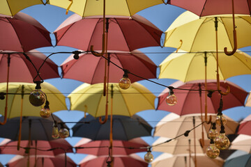 Outdoor ceiling installation made of lots of colorful umbrellas