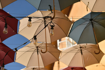 Outdoor ceiling installation made of lots of colorful umbrellas