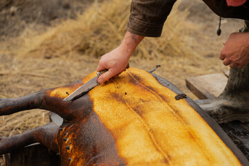 Men wash a pig after slaughtering it according to a Romanian tradition before Christmas.