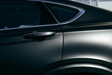 Obraz na płótnie Canvas side part of black matte luxury car