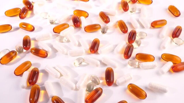 Various white, orange and transparent Capsules isolated on white Background - Healthy Nutrition Pills