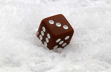 A die on snow, concept of luck, or frozen chance