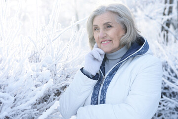 Old woman in a fur coat in the winter 