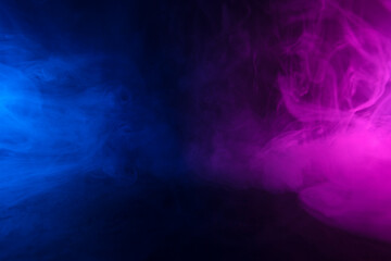 Colorful clouds of smoke in neon light abstract background