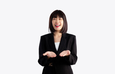 Pretty asian woman in business jacket suit posing smiling and hand showing presenting on white background.
