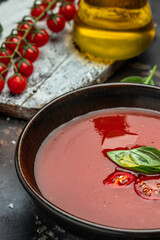 Spicy Homemade Gazpacho Soup. Summer cold vegan food on a dark background. banner, menu, recipe place for text, top view