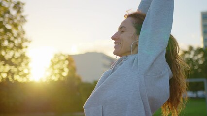 Close up of athletic young female exercising, stretching and doing yoga. Beautiful woman in sports clothes practising breathing technique and exercises
