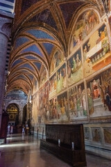 Fototapeta na wymiar San Gimignano, Italy, 15 April 2022: Beautiful frescoes in the medieval cathedral