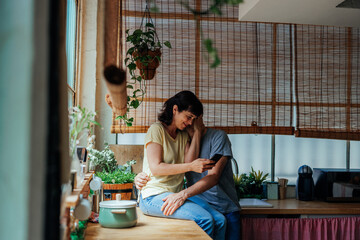 Husband hugging wife in kitchen