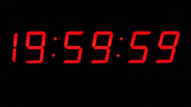 Digital timer on a black background. Light panel with red numbers. 20 o'clock